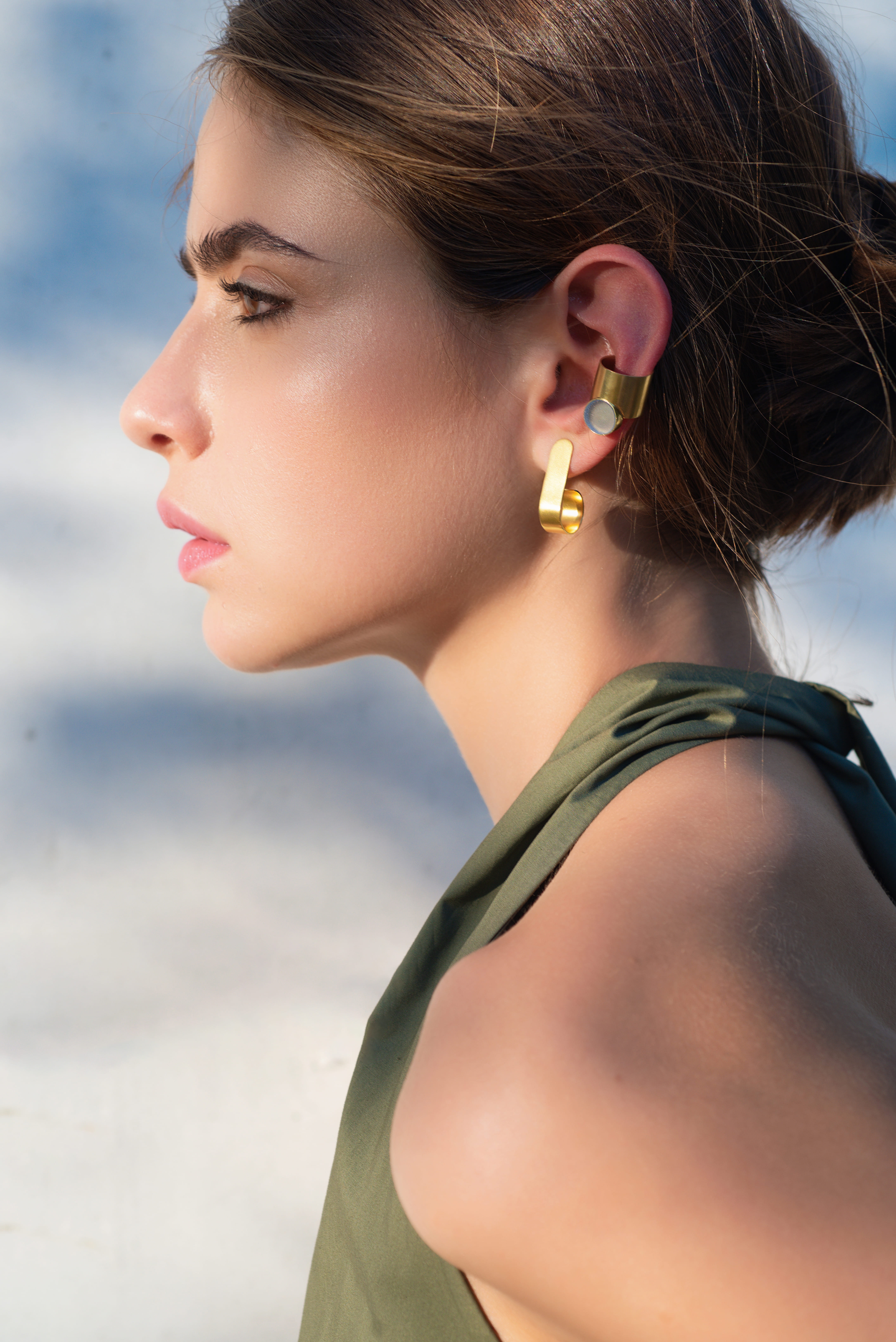 woman wearring gold earring